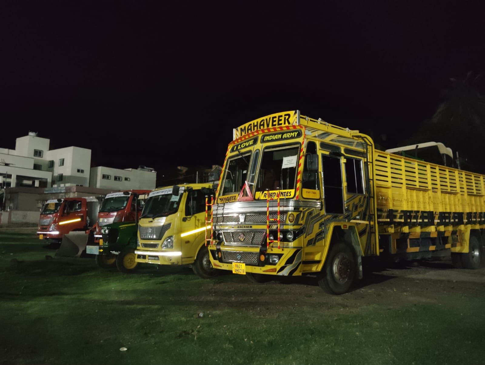 The Royal Mahaveer Roadlines branded trucks lined up at night