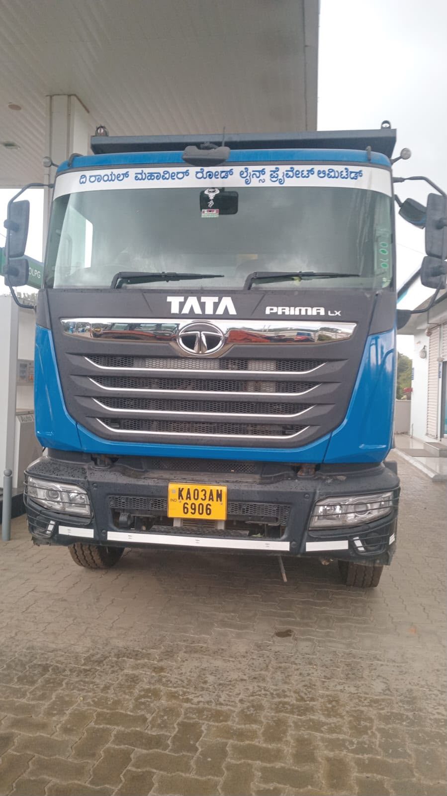 Tata Prima LX truck of The Royal Mahaveer Roadlines bearing the company name in Kannada